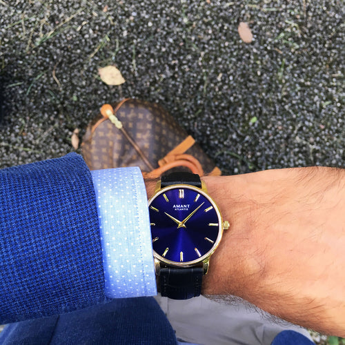ATLANTIS watch on wrist: dark blue dial with gold hands and black strap