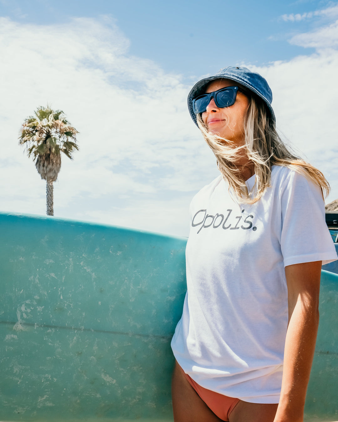 Devlin sunglasses on model, dark smoke lenses and turquoise frame