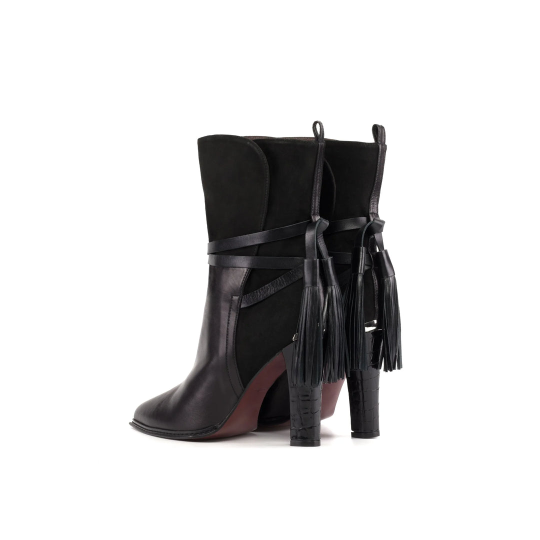 Black ankle booties with high stiletto heel and hanging tassel strap detail