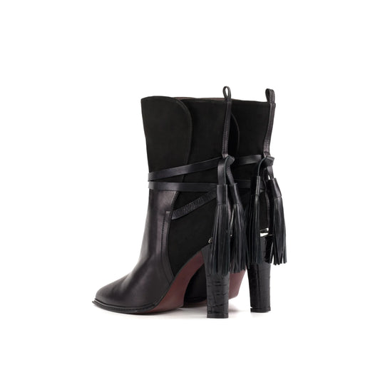 Black ankle booties with high stiletto heel and hanging tassel strap detail