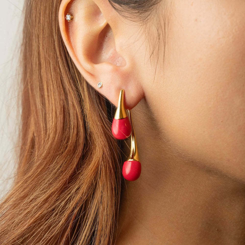 Pink Flamingo double drop earrings on ear with gold-tone hook closure.