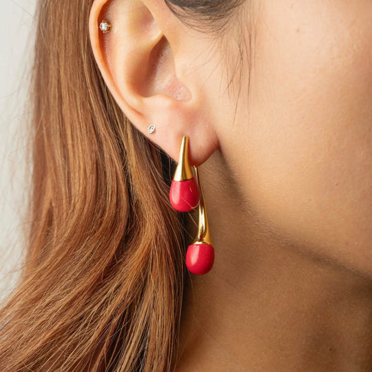Pink Flamingo double drop earrings on ear with gold-tone hook closure.