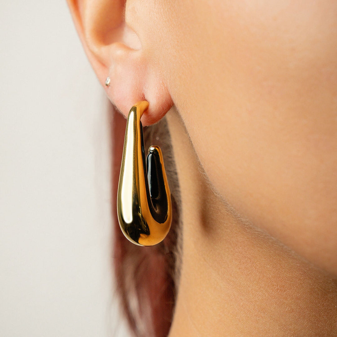 Drop hoop earrings with gold-tone hoops and dark black enamel inner