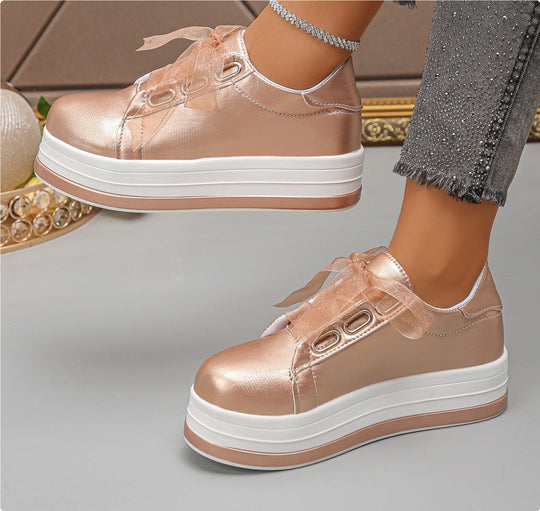 Metallic rose gold lace-up platform sneakers with round toe and white sole