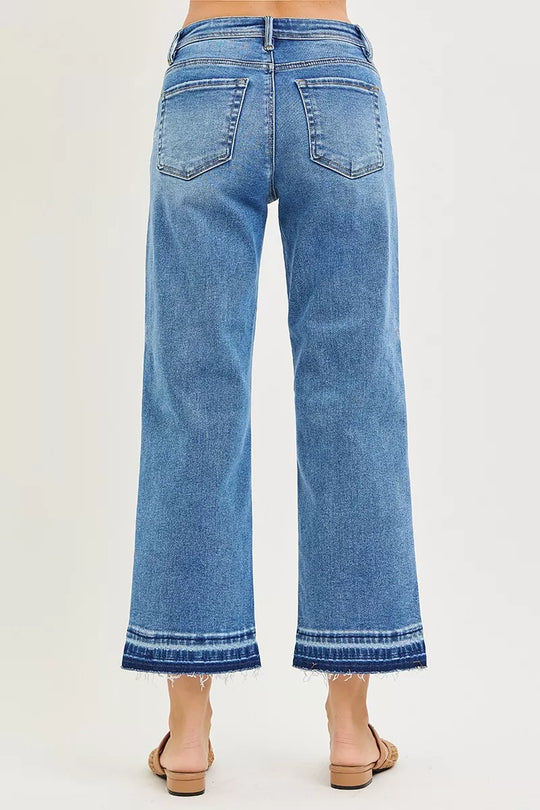 Medium wash cropped jeans, back view with belt loops and two back pockets, frayed hem