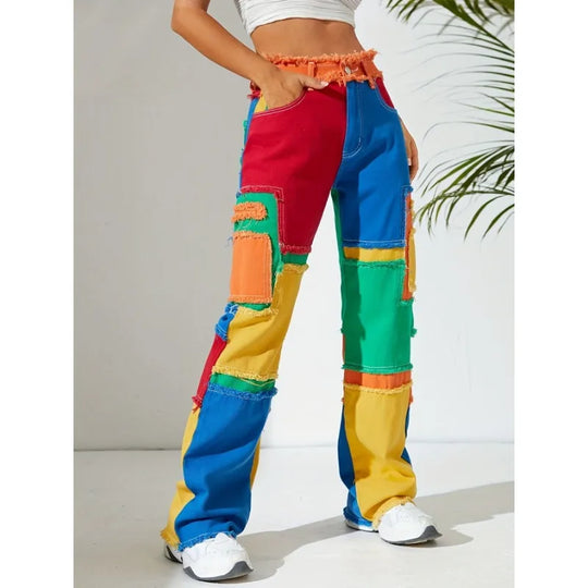 High-waist patchwork denim pants with multicolor blocks and frayed hem cuffs