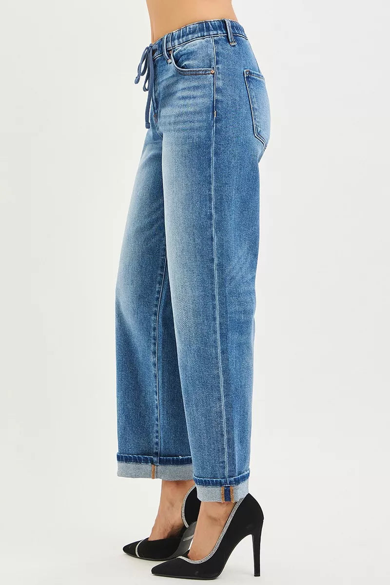 Side view: medium wash boyfriend jeans with elastic waist tie and cuffed hem