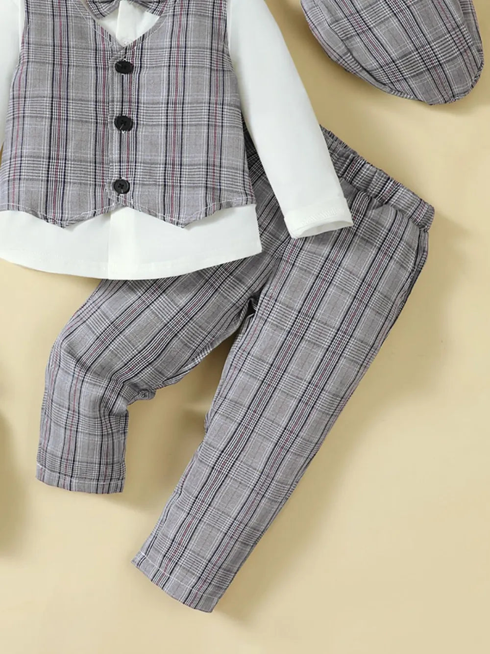 Gray plaid pants with buttoned plaid vest front and white long sleeves
