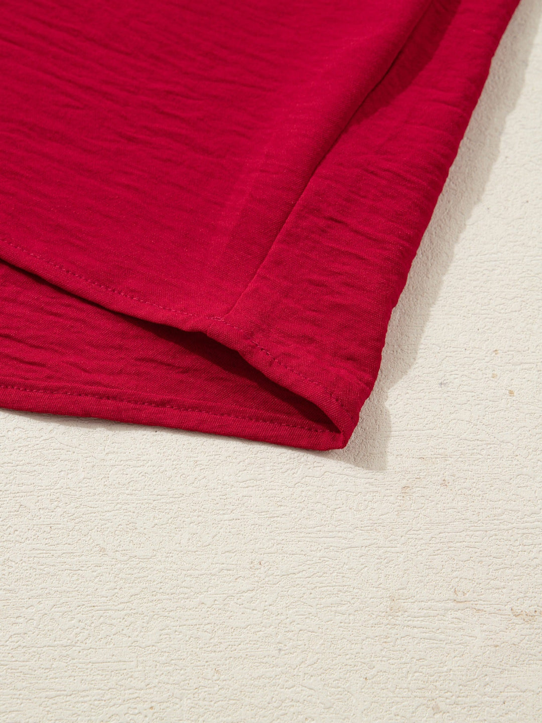 Deep Red half-sleeve blouse hem with neat stitching and gathered sleeve edge