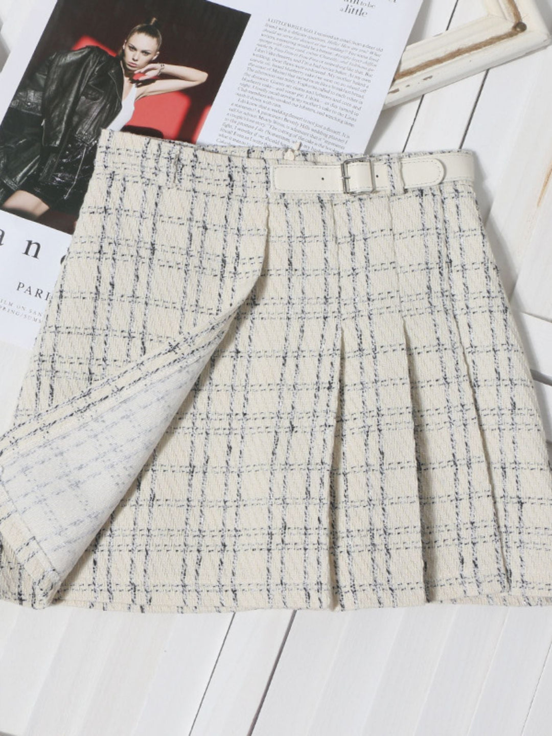 Pleated plaid mini skirt in beige with blue grid lines and stitched front pleats