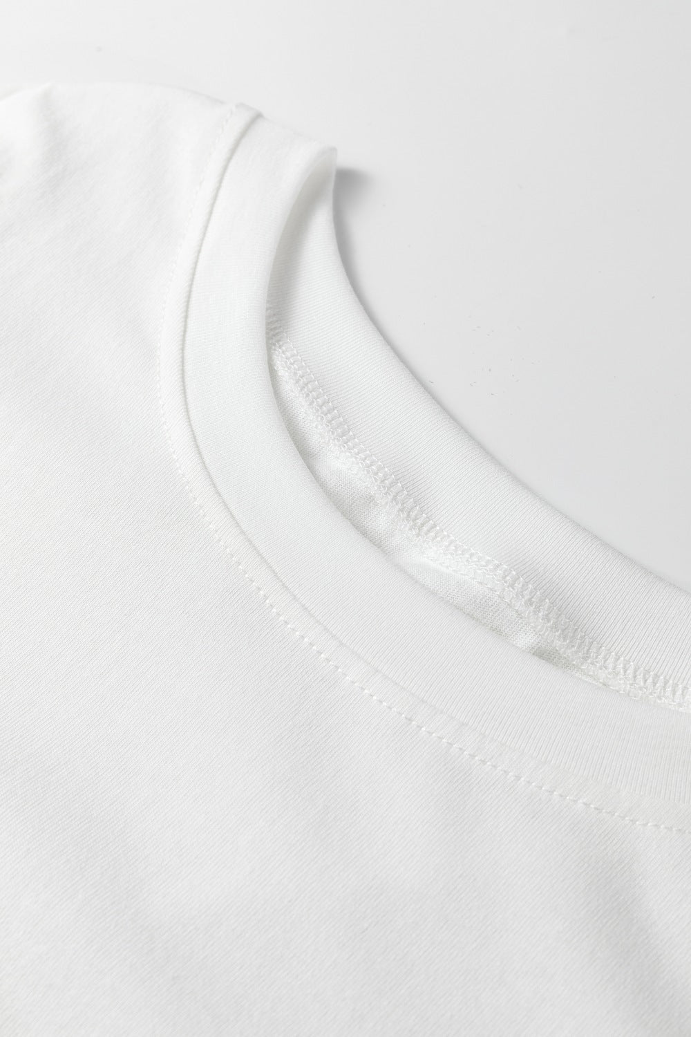 White T-shirt neckline and curved sleeve seam detail