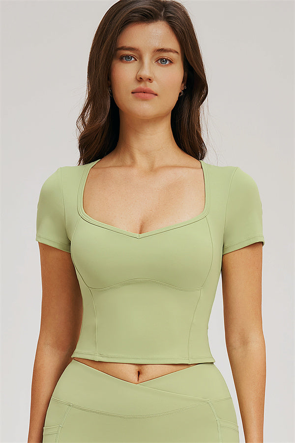 Light olive green scoop-neck cropped T-shirt with fitted leggings set, front