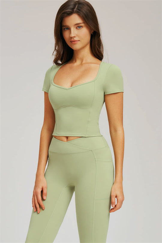 Front view of light olive green cropped T-shirt with seamless-style leggings set