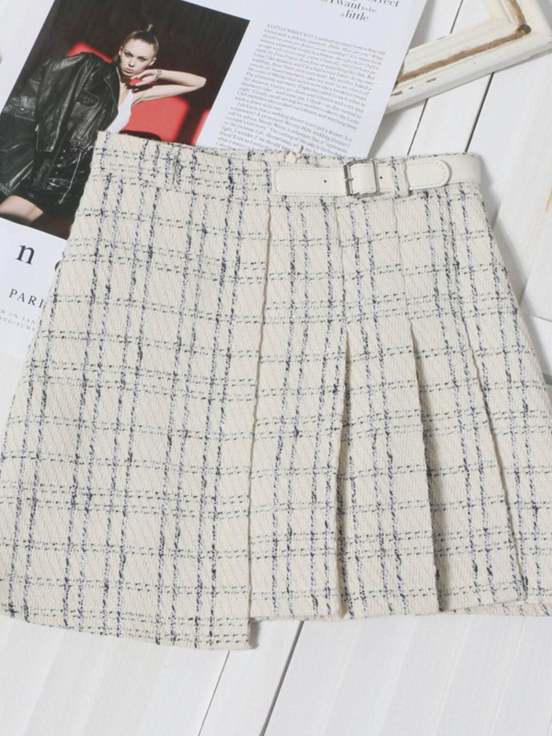 Beige pleated plaid mini skirt with A-line cut and blue windowpane pattern