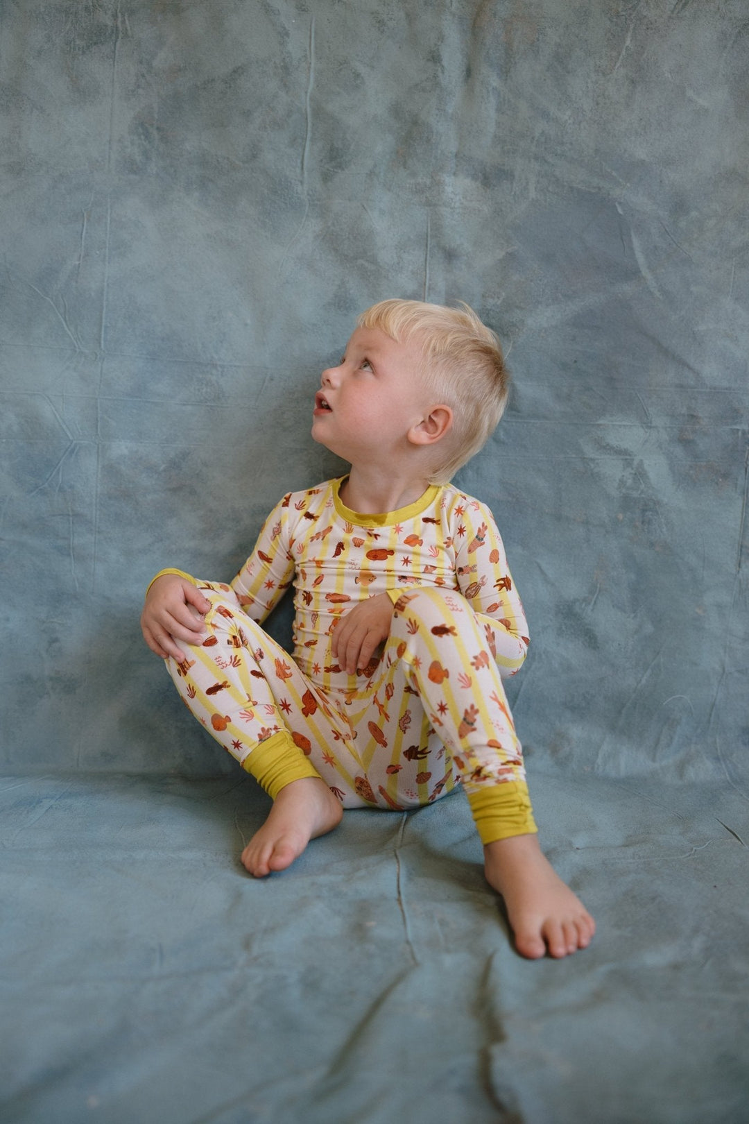 Fancy Fins two-piece pajama set on child: long-sleeve top and matching pants with yellow cuffs