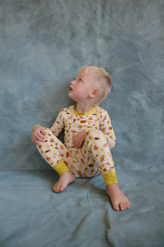 Fancy Fins two-piece pajama set on child: long-sleeve top and matching pants with yellow cuffs