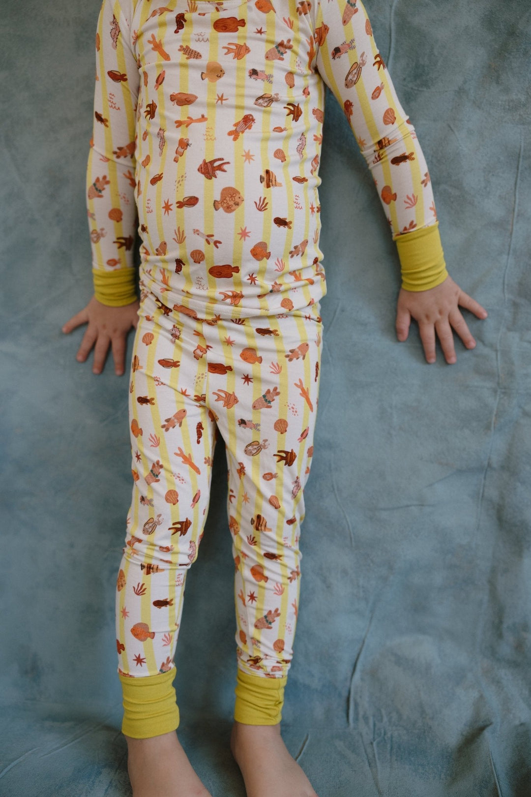 Fancy Fins pajama pants with critter print and yellow cuffs at ankle