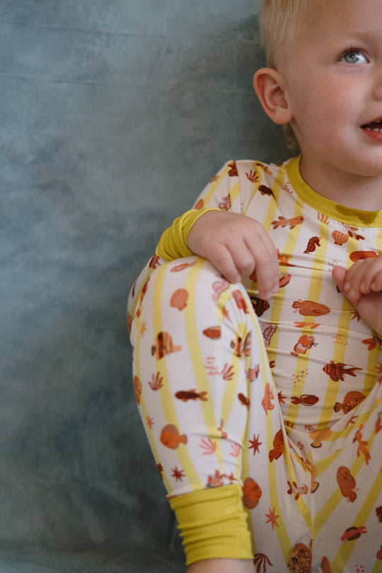 Kids long-sleeve pajama top with Fancy Fins critter print and yellow cuffs