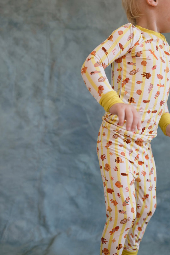 Side view of Fancy Fins pajama set: long-sleeve top and pants with yellow sleeve cuffs