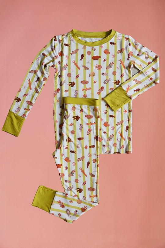 Fancy Fins two-piece set: long-sleeve pajama top and pants with playful critter print, yellow trim