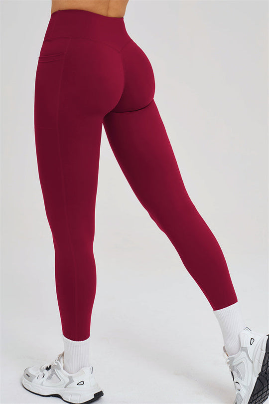 Burgundy high-waist leggings, ankle length with seam details, side view