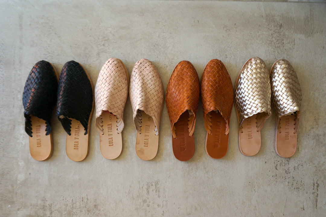 Hand-woven leather slides assortment, featuring camel braided pair