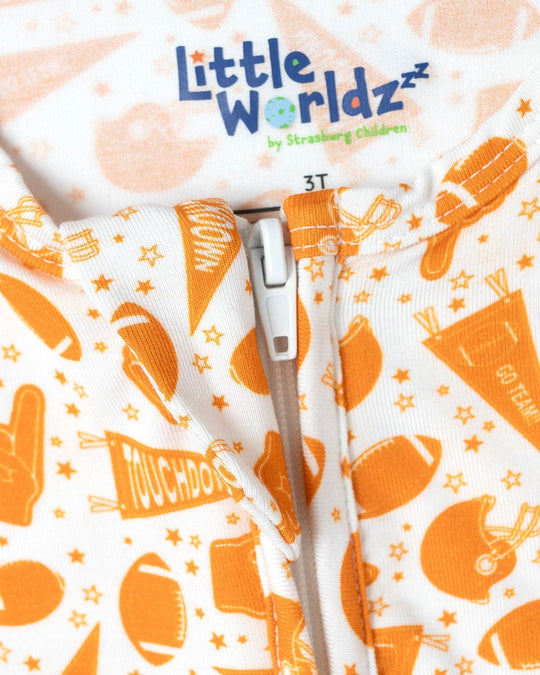 Orange-and-white football print bamboo pajama fabric close-up with size 3T label