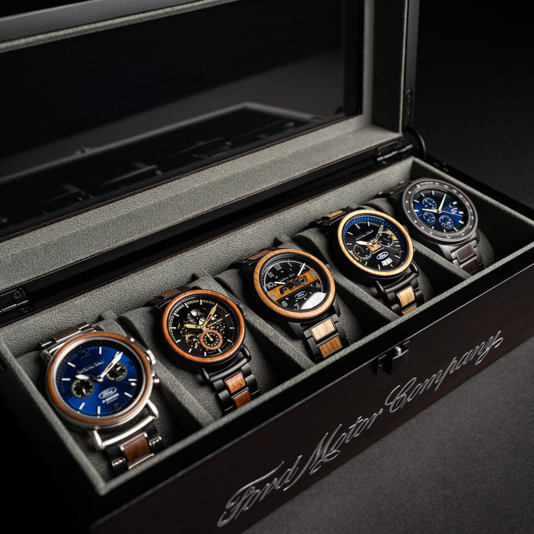 Ebony 5-watch holder interior with several round watches in fitted slots