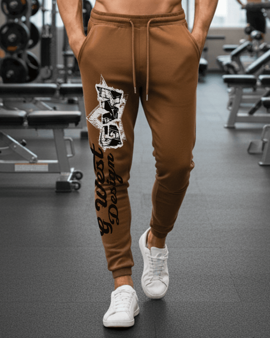 Brown jogger pants with graphic print, drawstring waist, ribbed cuffs