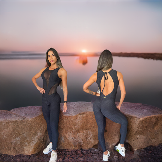 Black sleeveless jumpsuit with front mesh panel and open-back tie detail