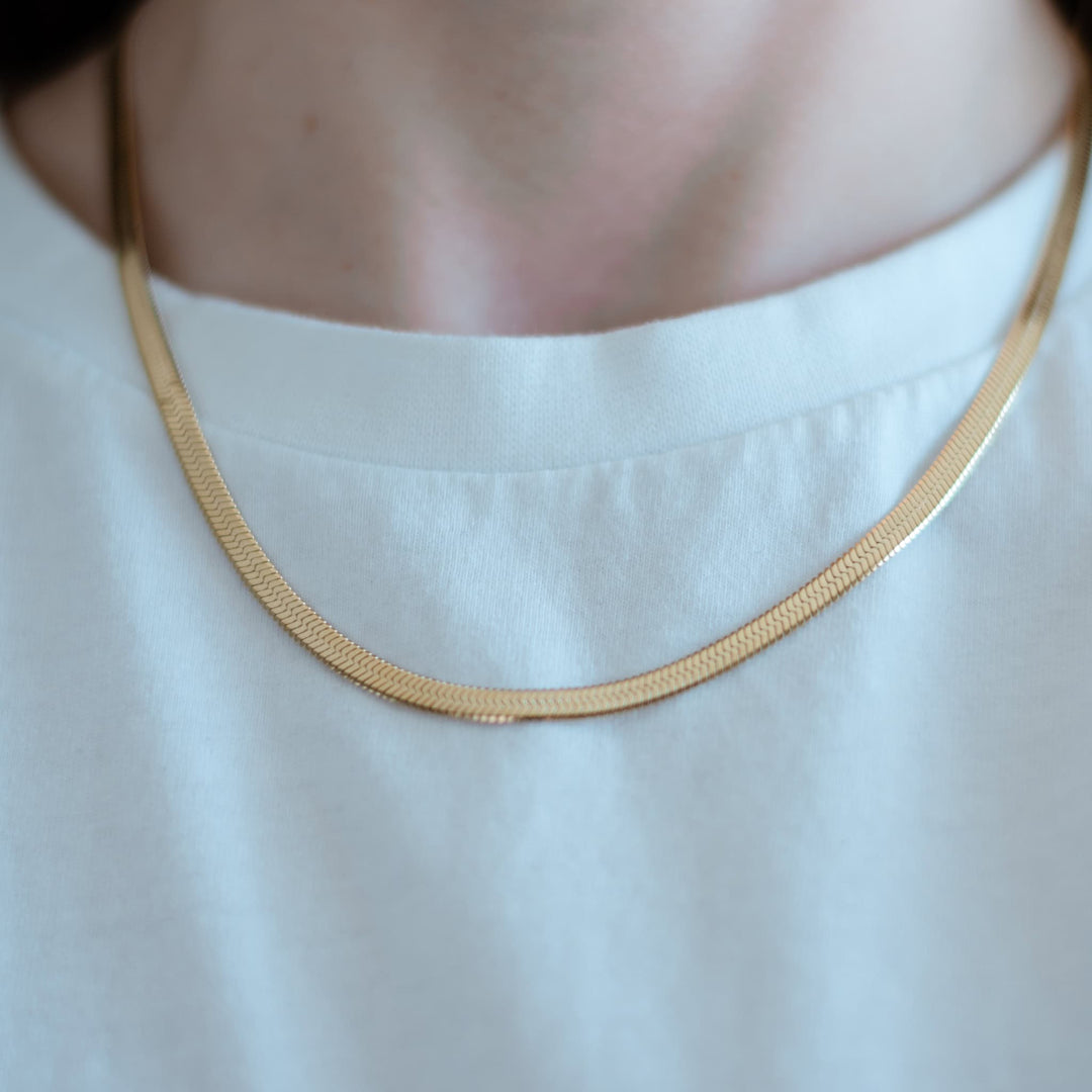 Kate Herringbone Chain Necklace in Gold, slim herringbone chain resting on neckline