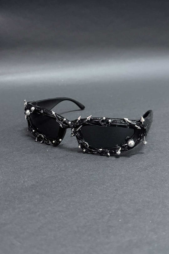 Spiked chain sunglasses with black lenses and chrome details, side view