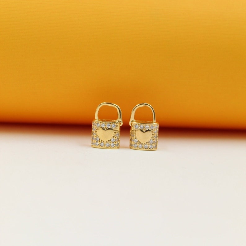 Lock heart huggie earrings, gold-tone with clear pavé and heart cutout