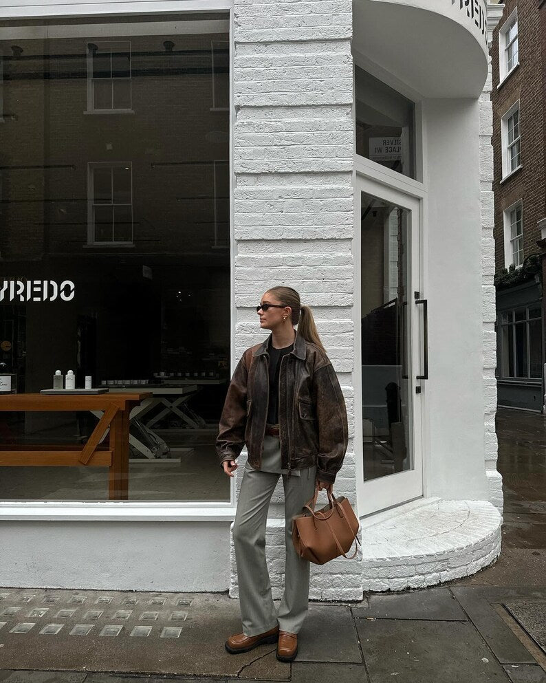 Oversized distressed brown leather jacket, full zip, front pockets, 3/4 view