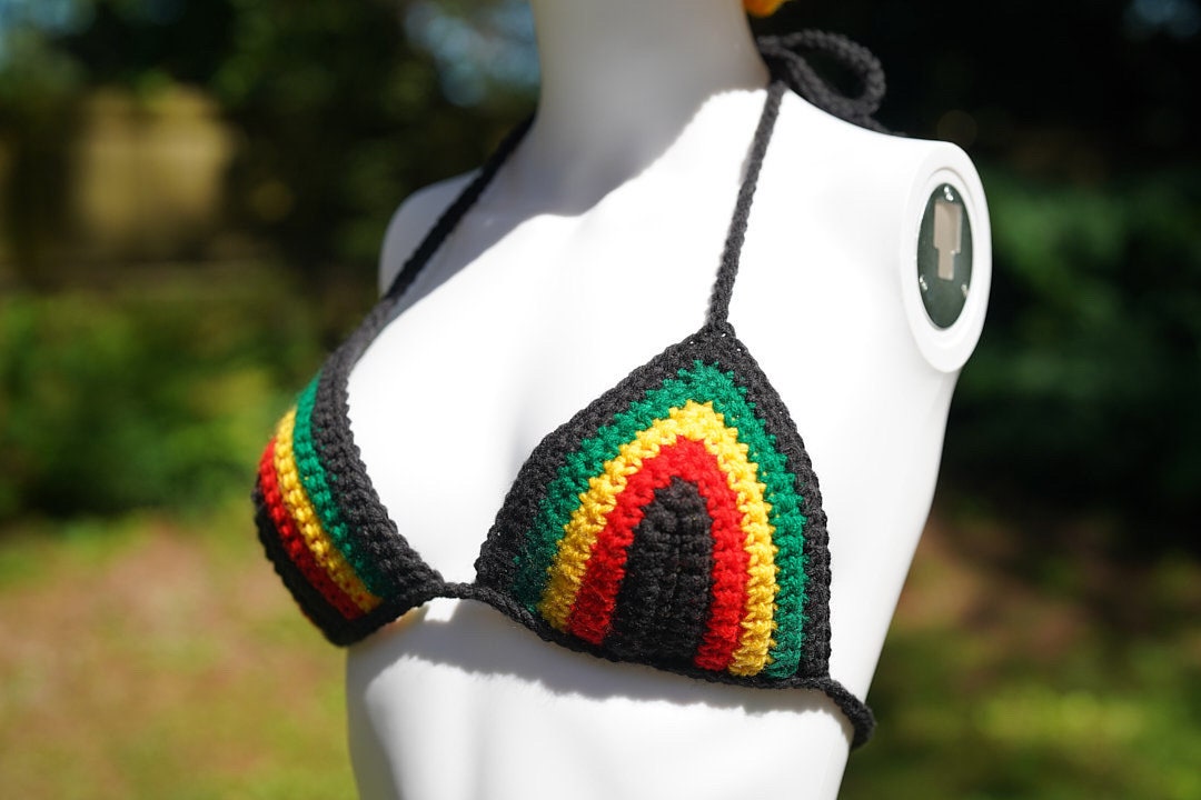 Crochet bikini triangle top with rainbow-striped panels in black, green, red, and yellow