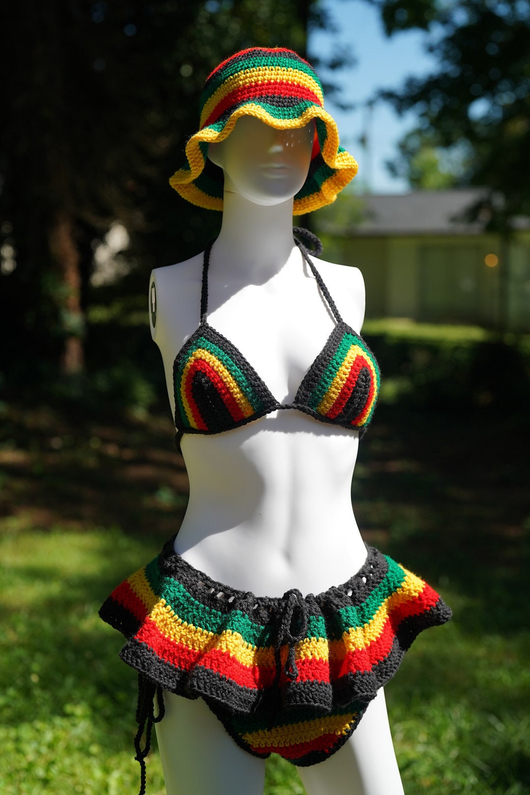 Rasta crochet bucket hat with triangle bikini top and micro mini skirt on a mannequin