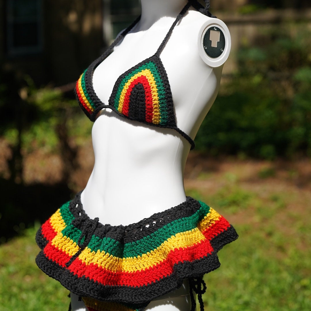 Crochet bikini top and micro mini skirt close-up on black, green, red, yellow stripes