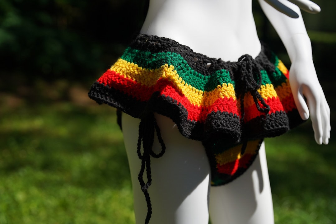 Micro mini skirt in crochet with black base and red, yellow, green rainbow stripes