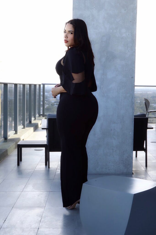 Black fashion jumpsuit with open back and cutout sleeves, wide-leg fit