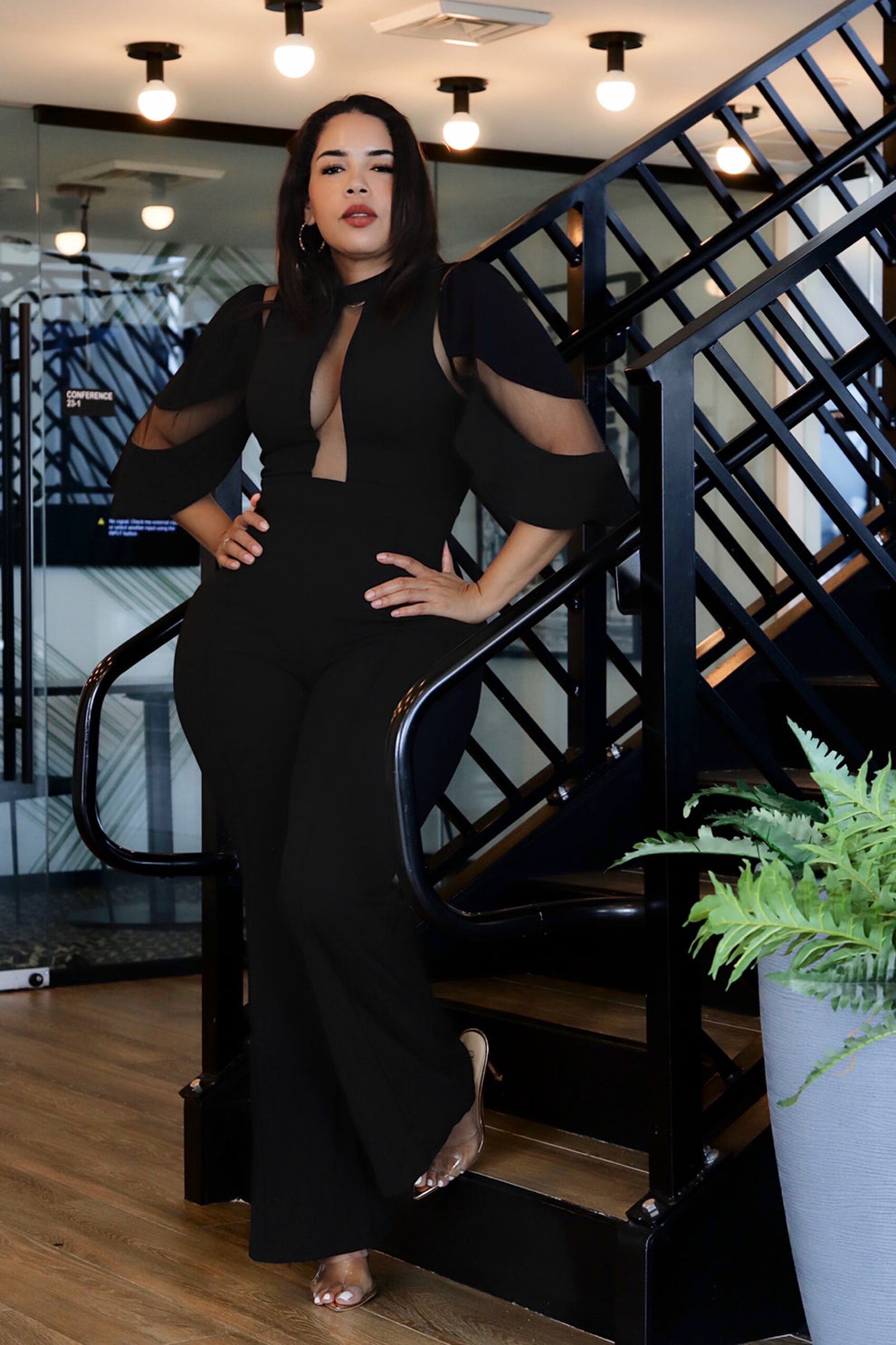 Black mesh-insert fashion jumpsuit with plunging neckline and bell sleeves