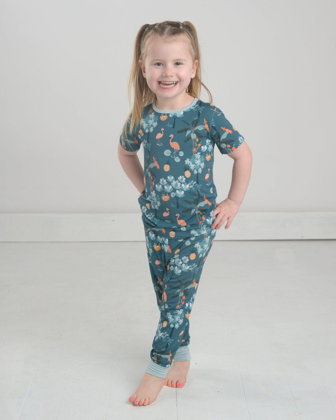 Jungle pajama set: teal long leggings with jungle animal and leaf pattern.
