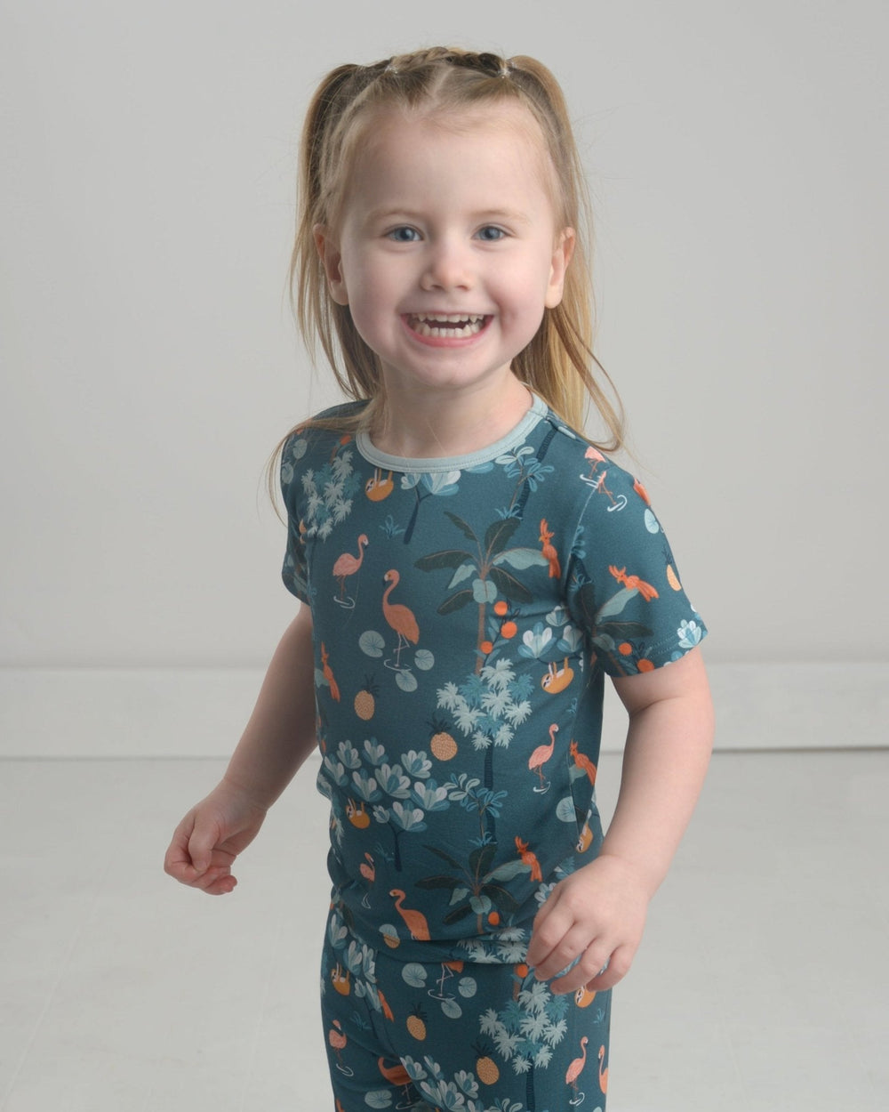 Jungle pajama set: teal short-sleeve crew top with animal and foliage print.