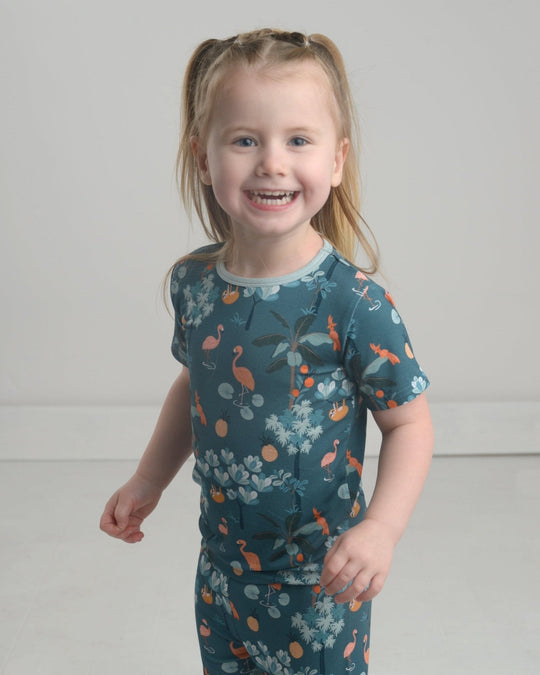 Jungle pajama set: teal short-sleeve crew top with animal and foliage print.