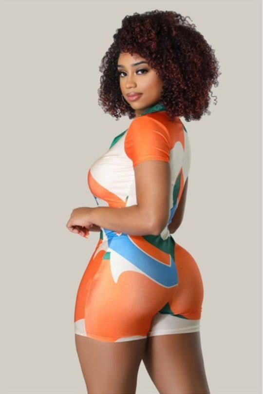 Side view Summer Moments romper with orange, green and blue geometric print shorts