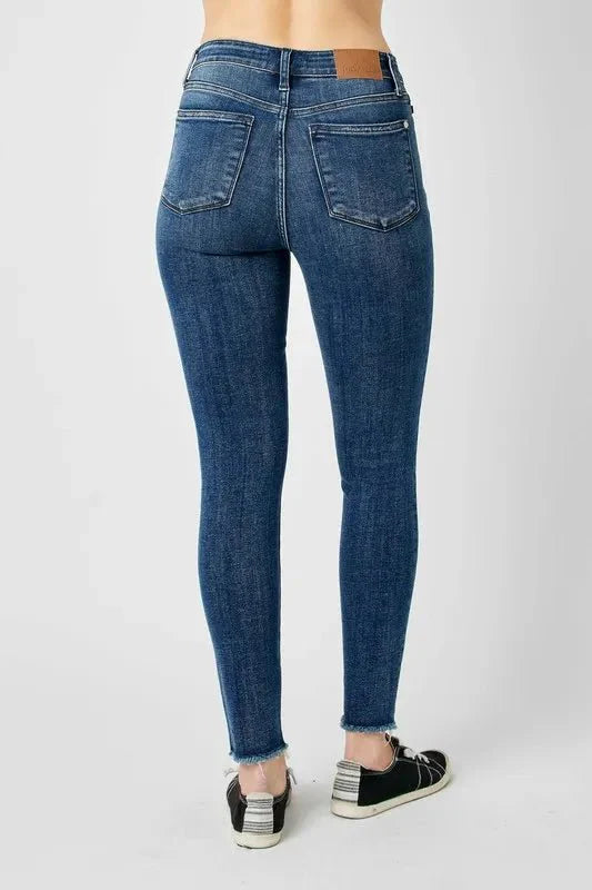 Dark high-waist skinny jeans, full back view with slim tapered fit