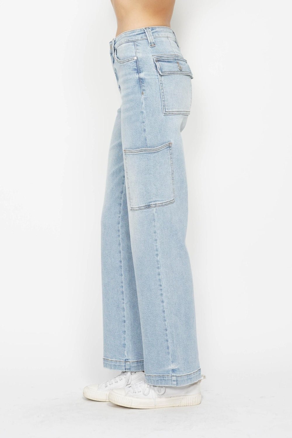 Back view of light wash high-waist straight cargo jeans with patch cargo pockets