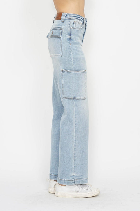 Side view of light wash high-waist straight cargo jeans with front patch pockets
