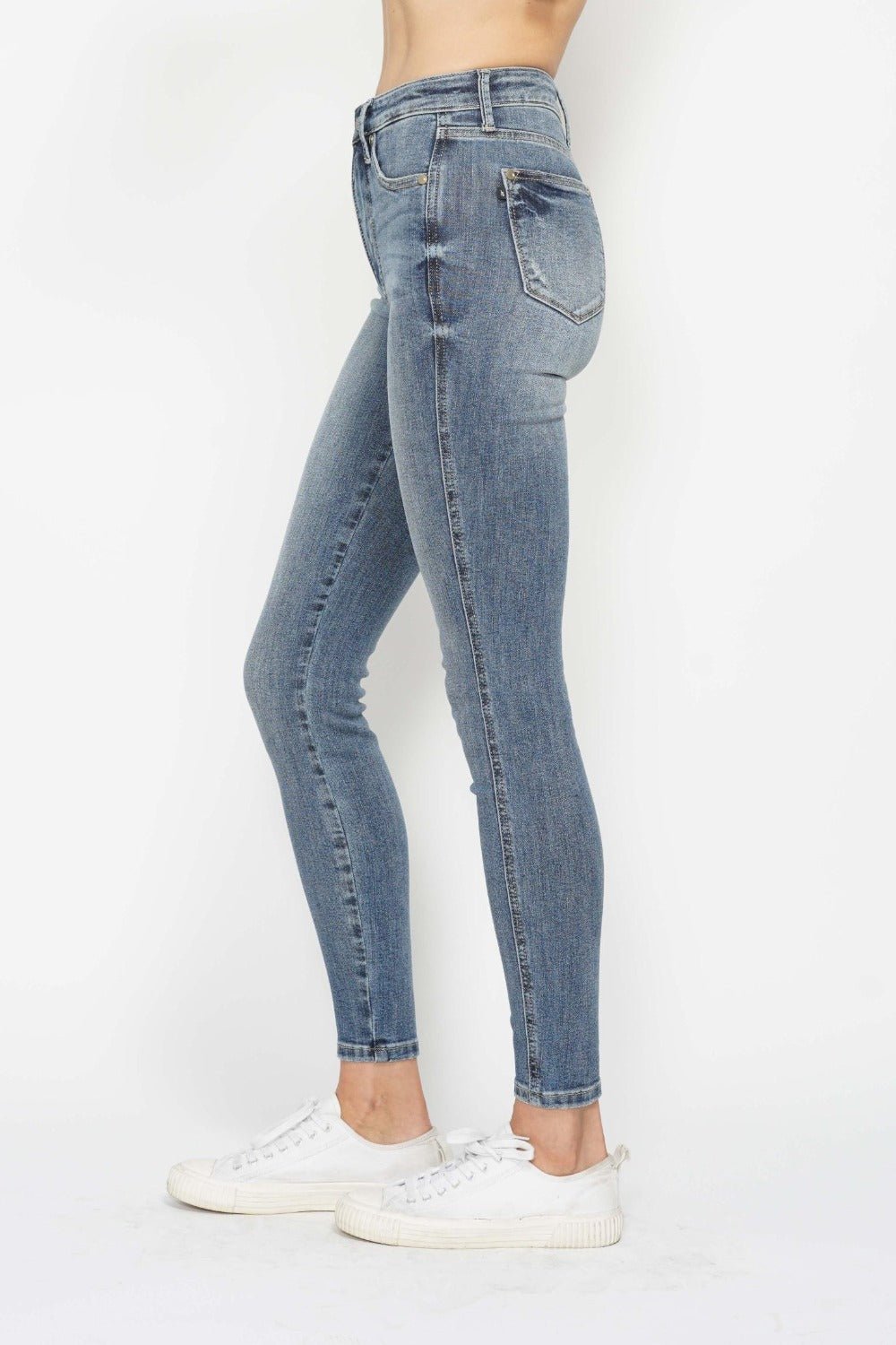 Side view medium wash skinny jeans with slim leg and cuffed hem