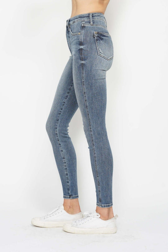 Side view medium wash skinny jeans with slim leg and cuffed hem