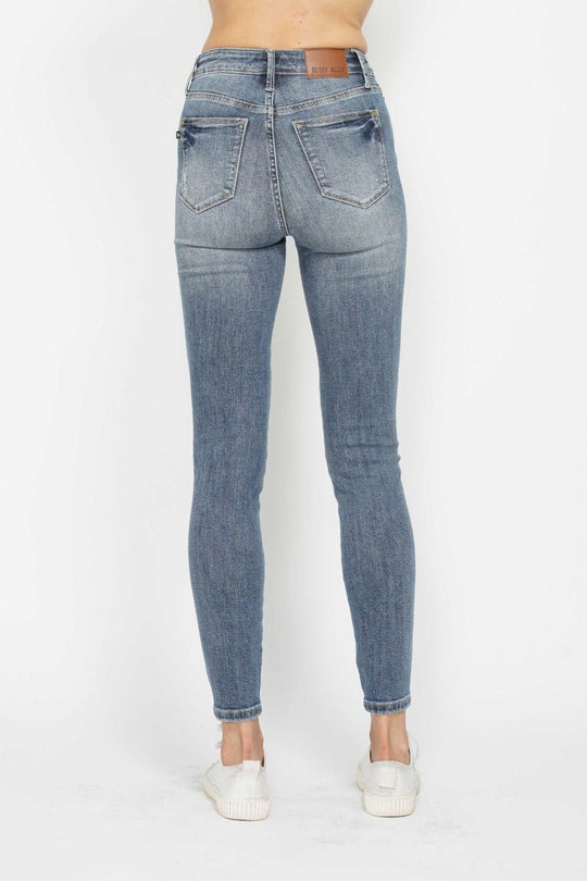 Back view medium wash skinny jeans with button fly and contrast whiskering